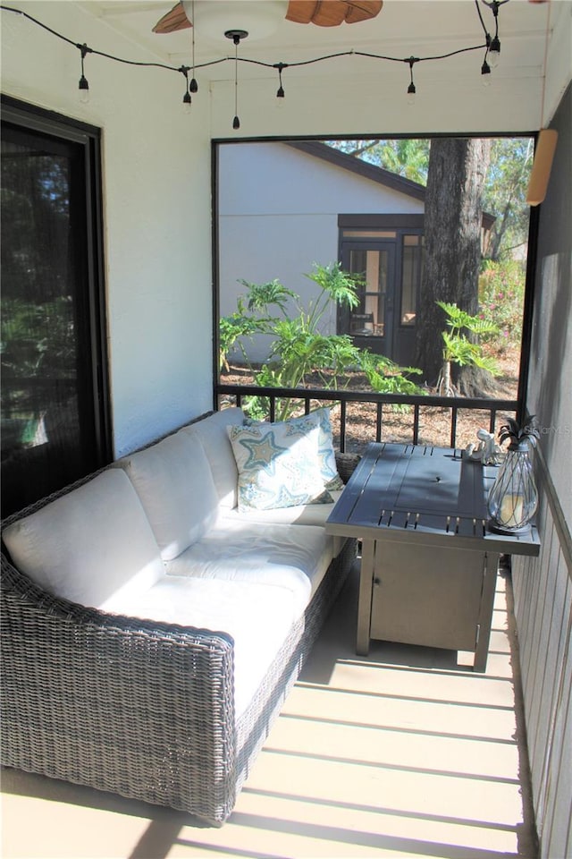 deck with an outdoor living space and a ceiling fan