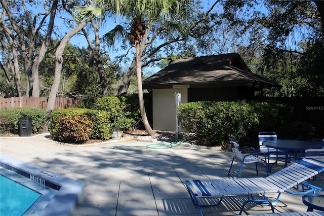 view of patio with outdoor dining space and fence