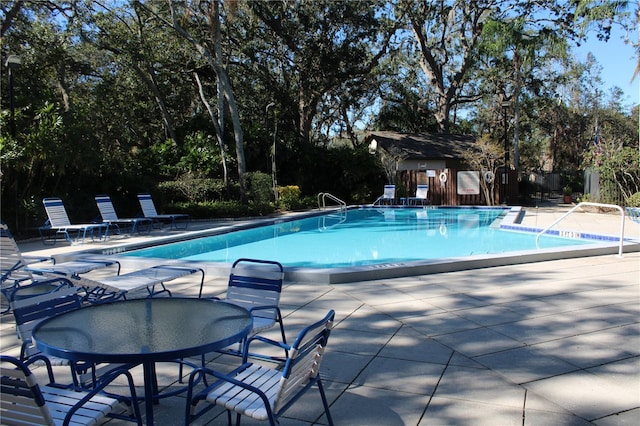 pool featuring a patio and fence