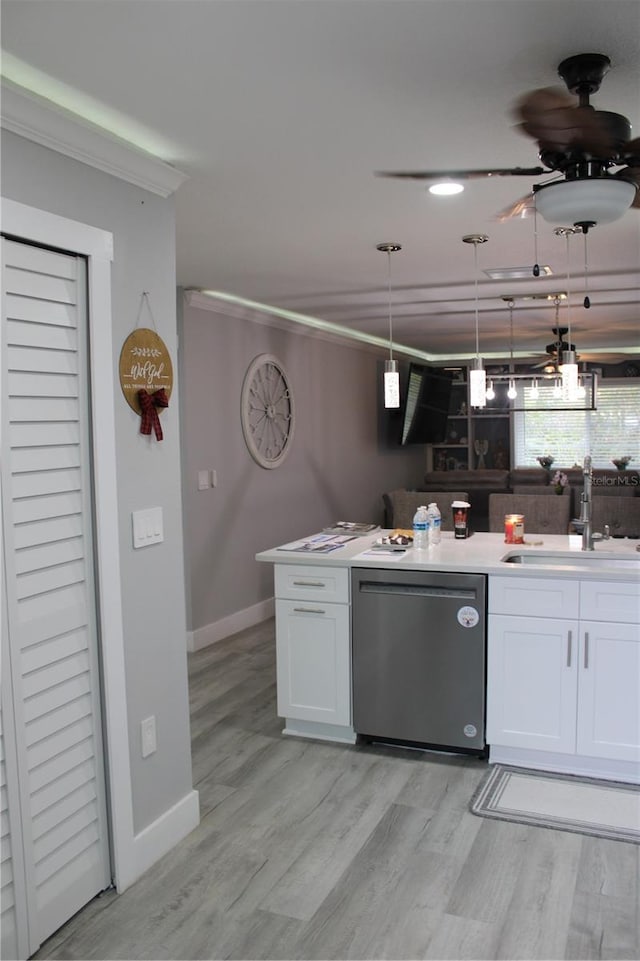 kitchen with crown molding, white cabinetry, dishwasher, and a sink