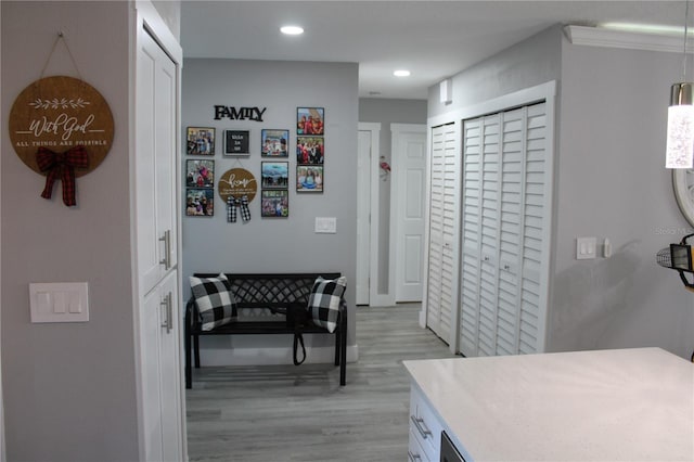 hallway with light wood-style flooring and recessed lighting