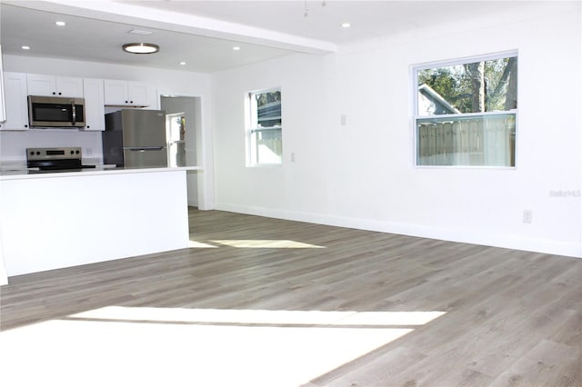 kitchen featuring white cabinetry, light hardwood / wood-style floors, and appliances with stainless steel finishes