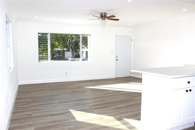 empty room with ceiling fan and dark hardwood / wood-style flooring