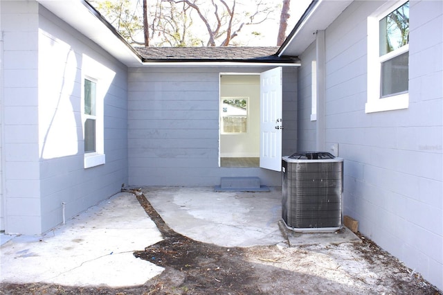 entrance to property featuring central air condition unit and a patio area