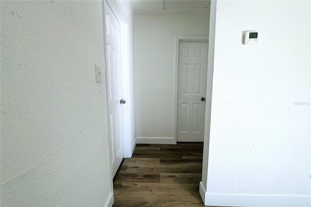 hallway with dark hardwood / wood-style floors