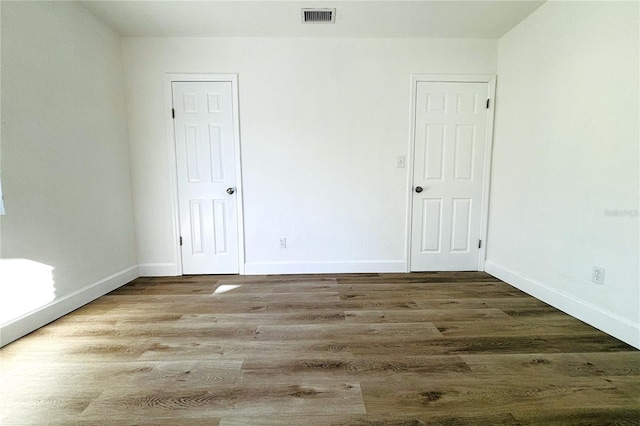 spare room with wood-type flooring