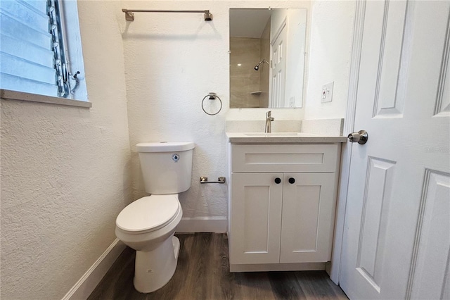 bathroom with hardwood / wood-style floors, vanity, and toilet