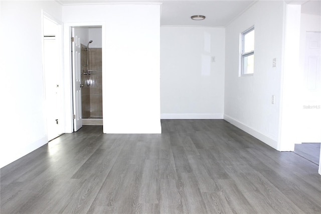 spare room featuring dark hardwood / wood-style floors and ornamental molding