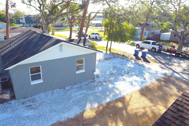 view of side of home with central air condition unit