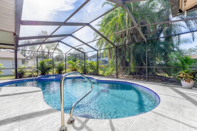 view of swimming pool featuring glass enclosure and a patio area