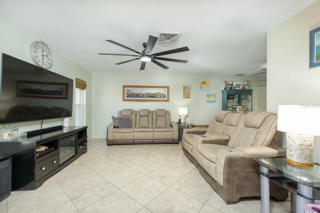 tiled living room featuring ceiling fan and a textured ceiling