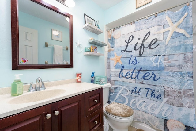 bathroom featuring a shower with shower curtain, vanity, and toilet