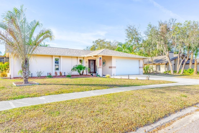 ranch-style house with a garage and a front lawn