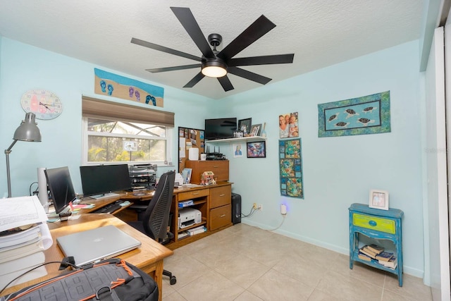 office area with a textured ceiling, ceiling fan, and light tile patterned flooring