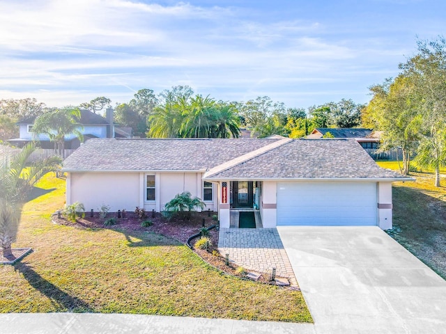 single story home with a garage and a front lawn