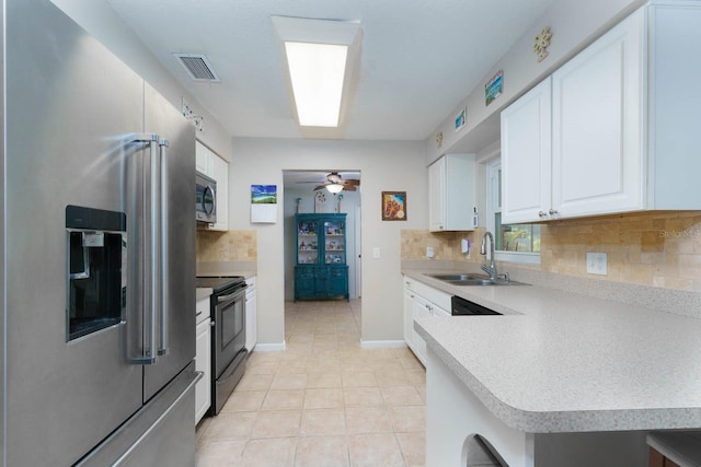 kitchen with white cabinetry, sink, ceiling fan, tasteful backsplash, and appliances with stainless steel finishes