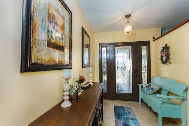 tiled entrance foyer with a textured ceiling