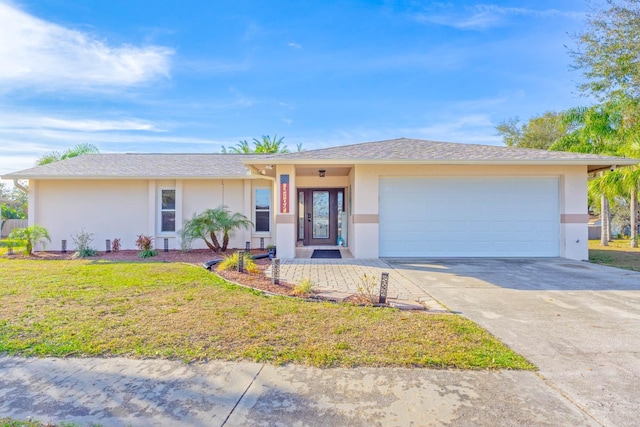 single story home with a front yard and a garage