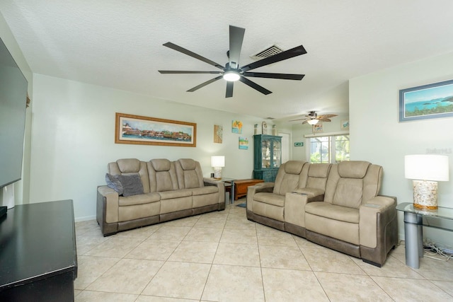 living room with light tile patterned flooring and a textured ceiling