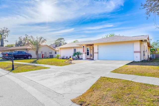 single story home featuring cooling unit, a front yard, and a garage