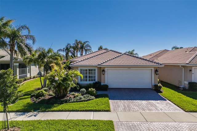 view of front of property featuring a garage and a front lawn