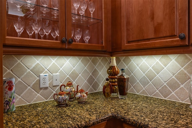 kitchen with tasteful backsplash and dark stone counters