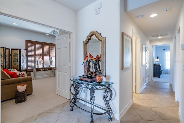 hallway featuring light colored carpet and a wealth of natural light