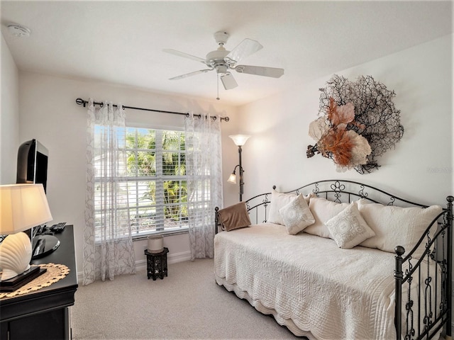 bedroom featuring ceiling fan and carpet