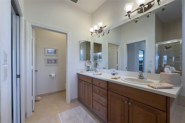 bathroom with toilet, vanity, tile patterned floors, and a shower with shower door