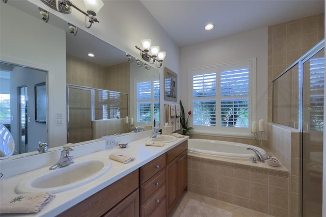 bathroom with tile patterned floors, vanity, separate shower and tub, and an inviting chandelier