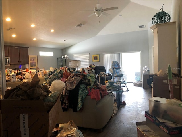 misc room featuring plenty of natural light, ceiling fan with notable chandelier, vaulted ceiling, and hardwood / wood-style flooring