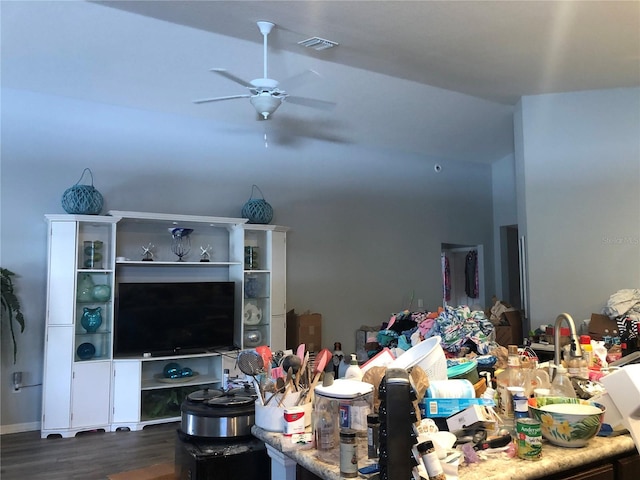 living room featuring lofted ceiling, ceiling fan, and dark wood-type flooring