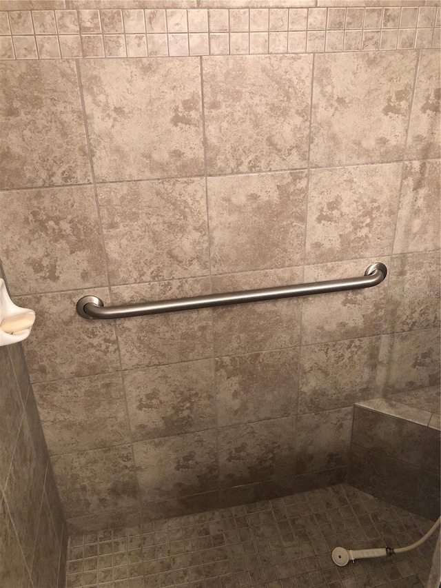 bathroom with a tile shower