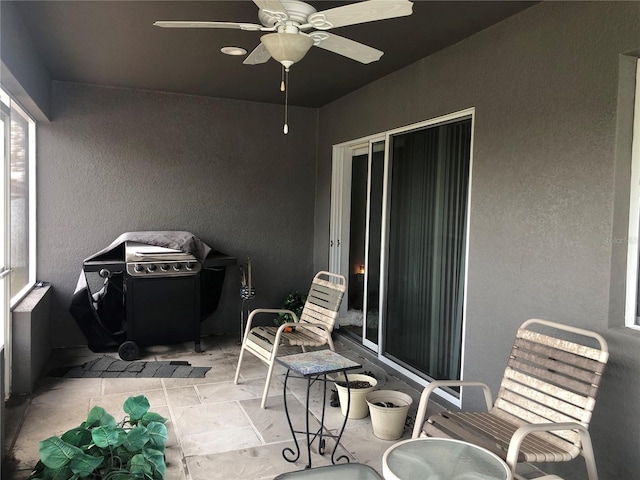 view of patio with ceiling fan and a grill