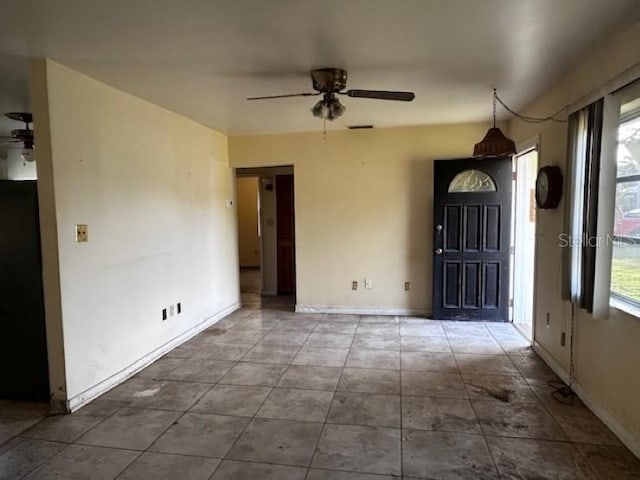 entrance foyer featuring ceiling fan and a wealth of natural light