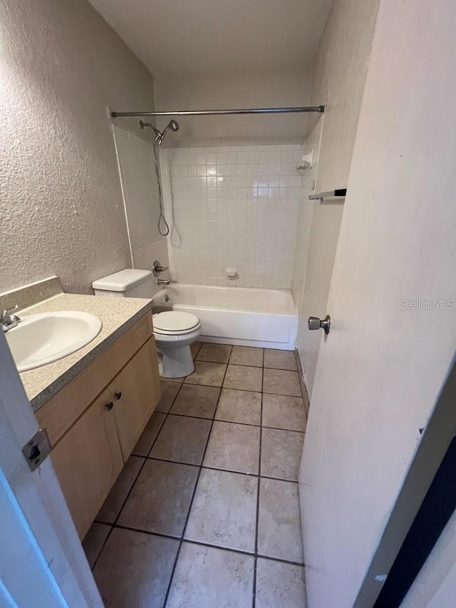 full bathroom featuring tile patterned floors, vanity, toilet, and tiled shower / bath