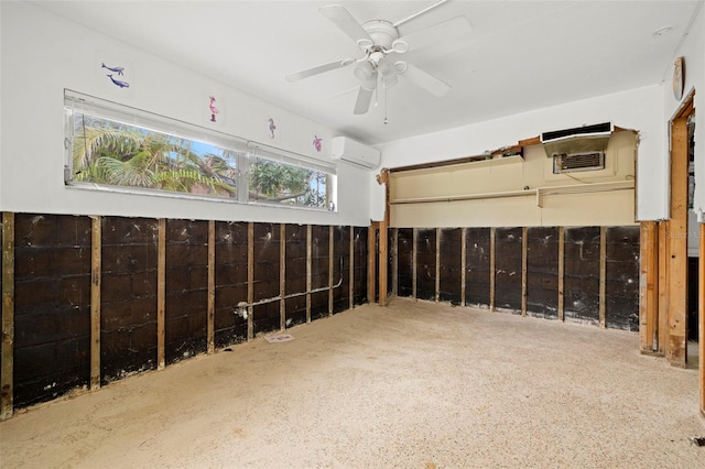 misc room featuring an AC wall unit and ceiling fan