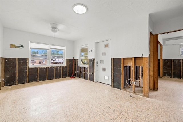 interior space with ceiling fan