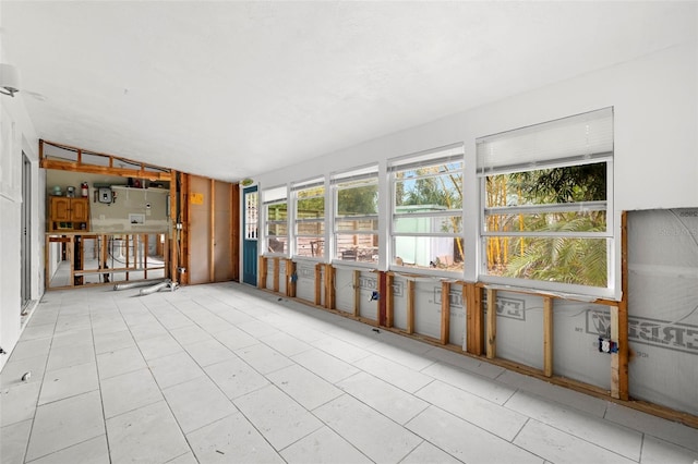 unfurnished sunroom with lofted ceiling