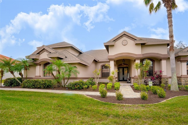 mediterranean / spanish house featuring a front lawn