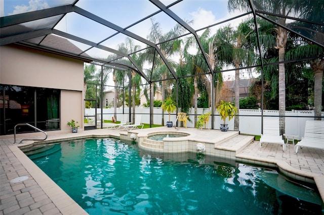 view of swimming pool with a patio area, an in ground hot tub, and glass enclosure