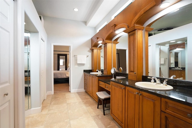 bathroom with tile patterned flooring, vanity, and ornate columns