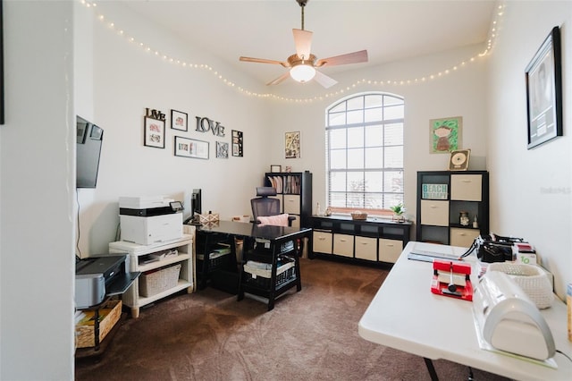 carpeted office space with ceiling fan