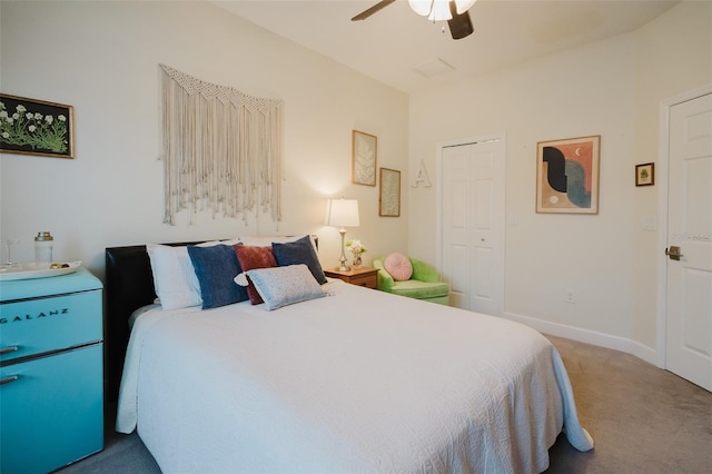 bedroom with ceiling fan, a closet, and carpet flooring