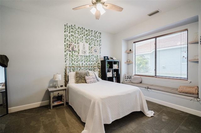 bedroom featuring ceiling fan and dark carpet