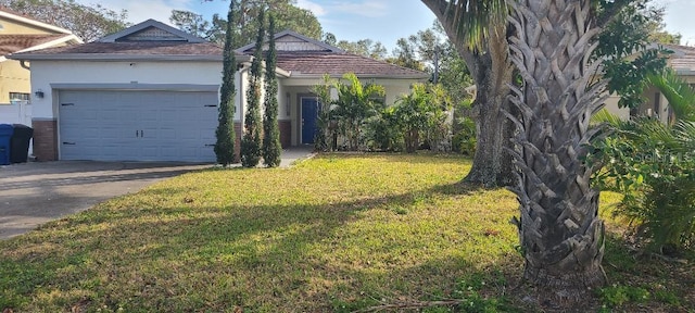 view of front of house featuring a garage and a front lawn