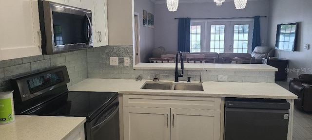 kitchen with black appliances, backsplash, white cabinets, and sink