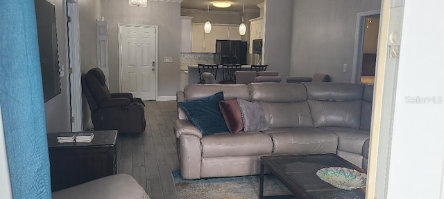 living room featuring crown molding and dark hardwood / wood-style flooring