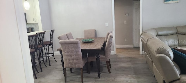 dining area with a fireplace and wood-type flooring