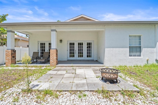 3611 19th St N, Saint Petersburg, FL 33713 - back of property featuring french doors, a fire pit, a patio, and stucco siding